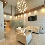 Beauty clinic corporate lobby interior design - https://www.andyquinones.net Httpswww Andyquinones Net beauty clinic lobby with stacked stone wall leather furniture glass partitions used for iv treatments and large chandelier